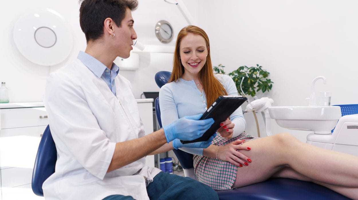 dentist showing treatment options to happy woman 2022 01 20 19 48 08 utc