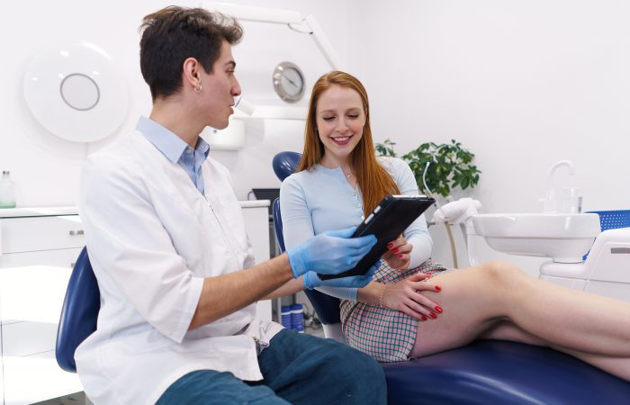 dentist showing treatment options to happy woman 2022 01 20 19 48 08 utc